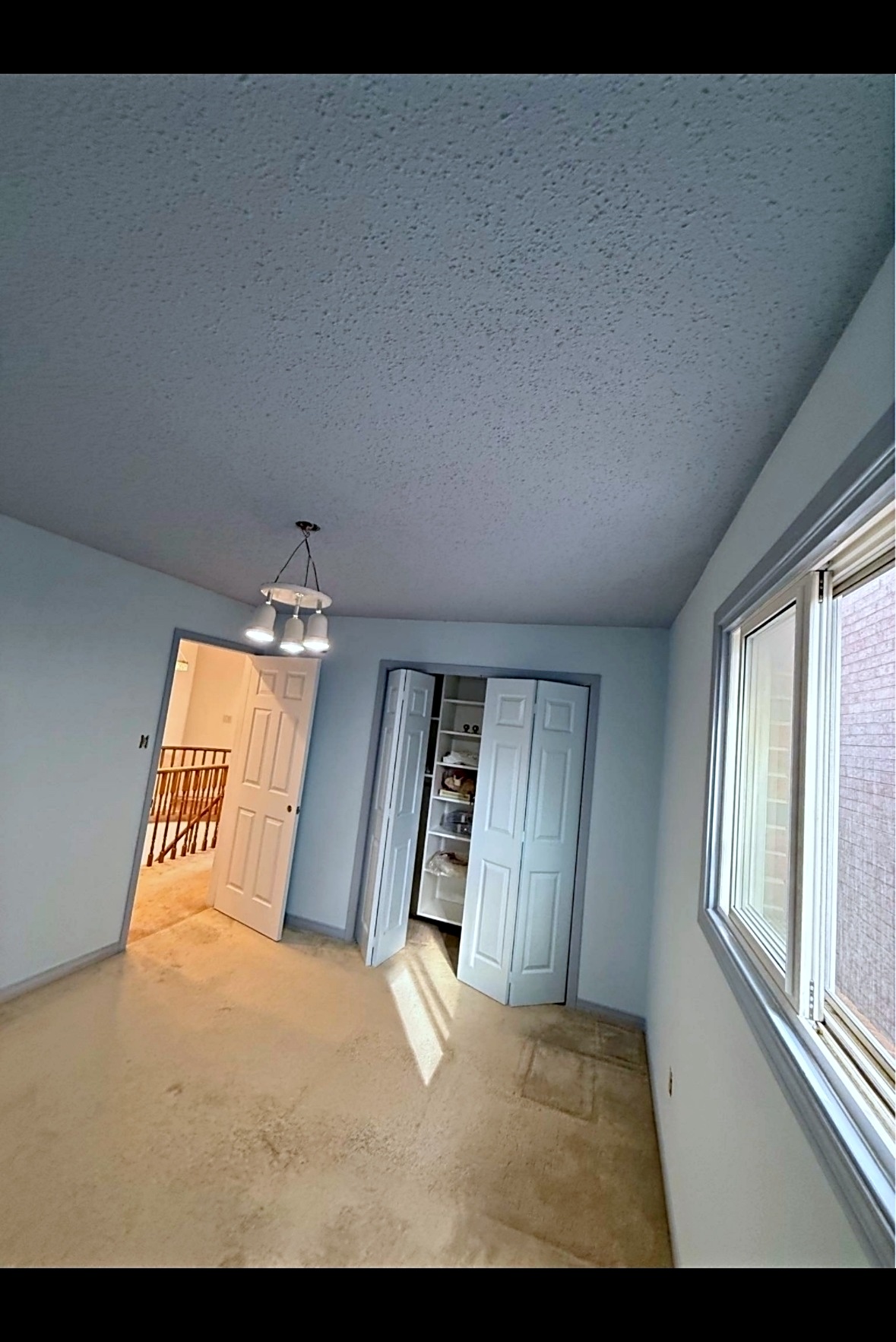 Finished basement with smooth gray walls and white trim